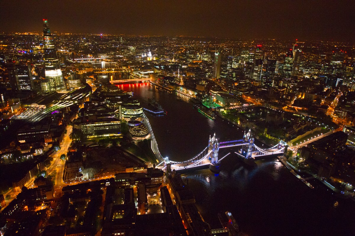 Aerial view of London up river towards the West, from above Tower Bridge. River Thames. Night. Lights.